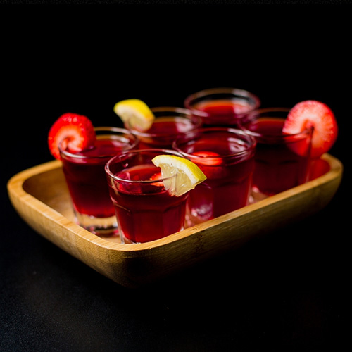 Six glasses of Beach Plum PB&J on a wooden tray