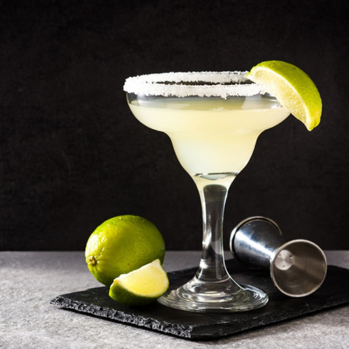 A Lemon Margarita with a salted rim and lime