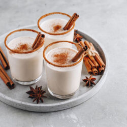 Three glasses of Oatmeal Chata on a tray with cinnamon