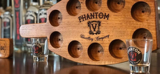 A Phantom V flight board and shot glasses